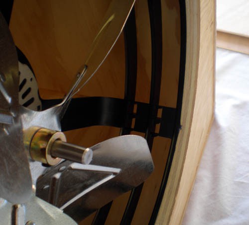 Close up photo of a fan mounted in a wooden box