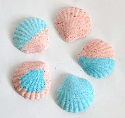 Five scallop shell figures colored in various patterns of pink and blue