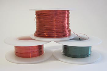 Three spools of red, orange and green magnet wire