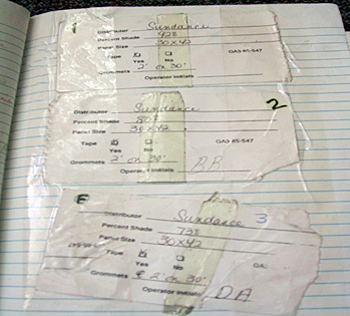 Loose papers are taped to a page in a notebook