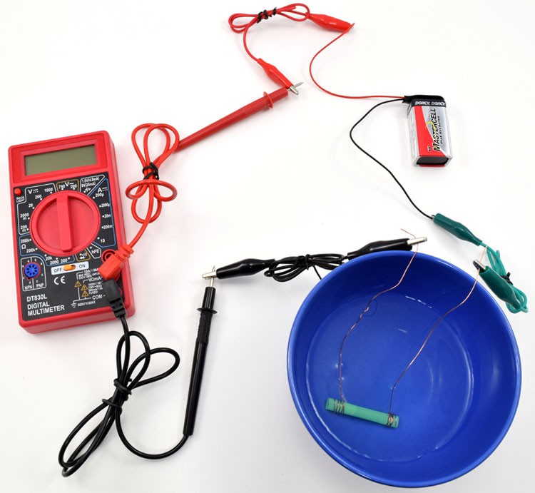 A multimeter, alligator clips, nine volt battery, copper wire, straw and a plastic bowl