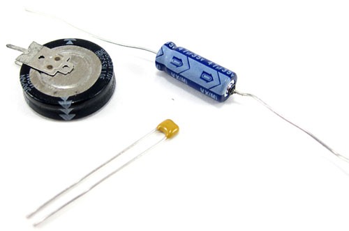 Three capacitors of different shapes and sizes