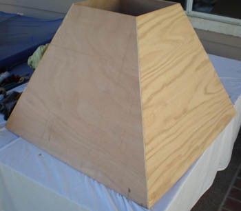 Four wooden panels in the shape of a trapezoid form the walls of a contraction cone