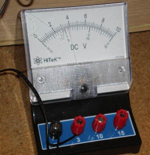 Two lead wires connect to a voltmeter